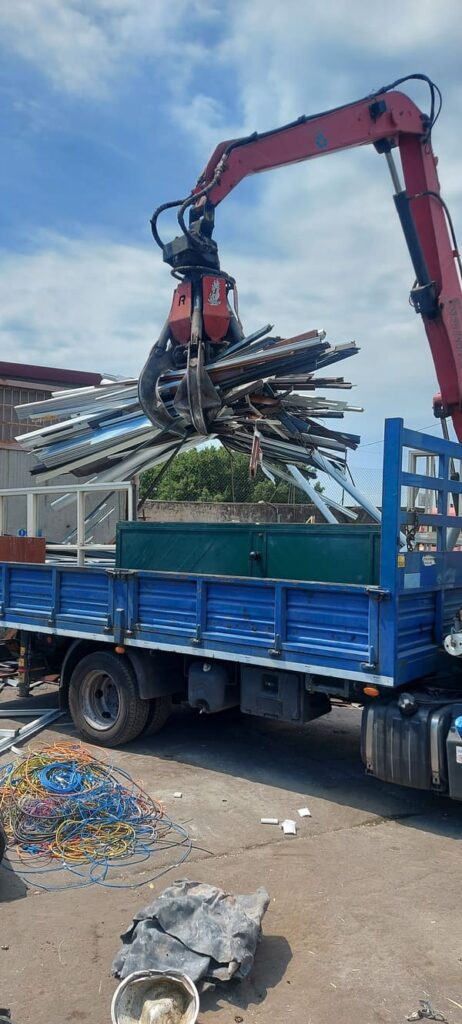 Crane loading scrap metal truck