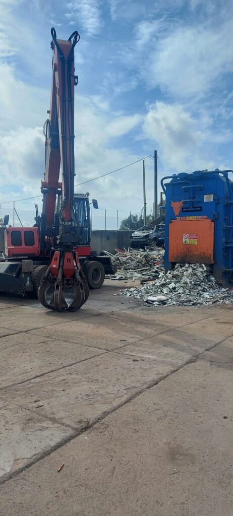 Excavator and metal scrap compactor