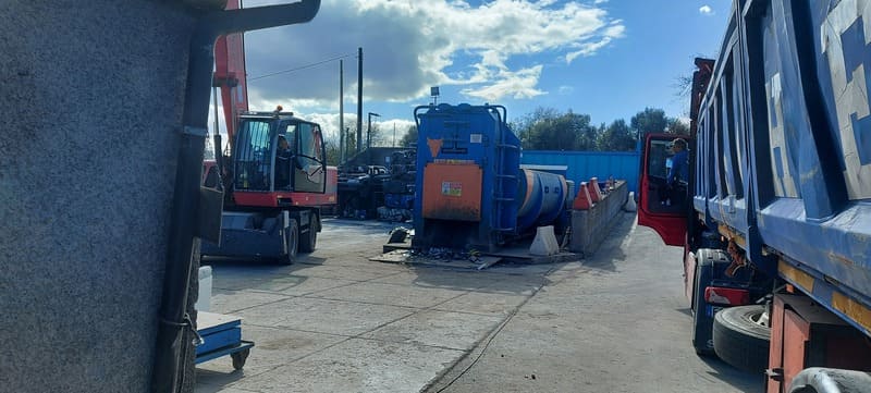 Scrapyard with machinery and trucks